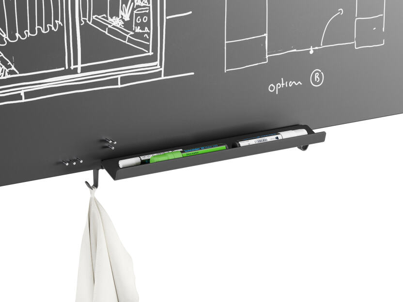 Black aluminium tray mounted to the bottom of a whiteboard that holds three markers and a cleaning cloth designed by Michel Charlot for FAUST Linoleum