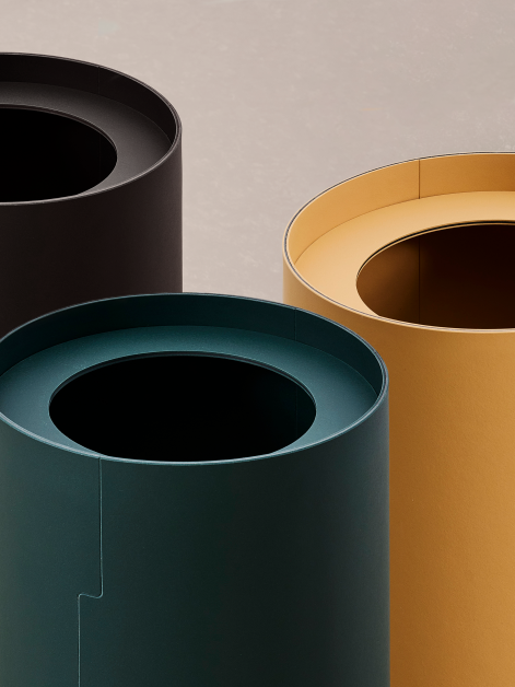 Close-up of a group of three TIDY paper bins designed by Keiji Takeuchi in Conifer, Leather, and Nero shades of linoleum